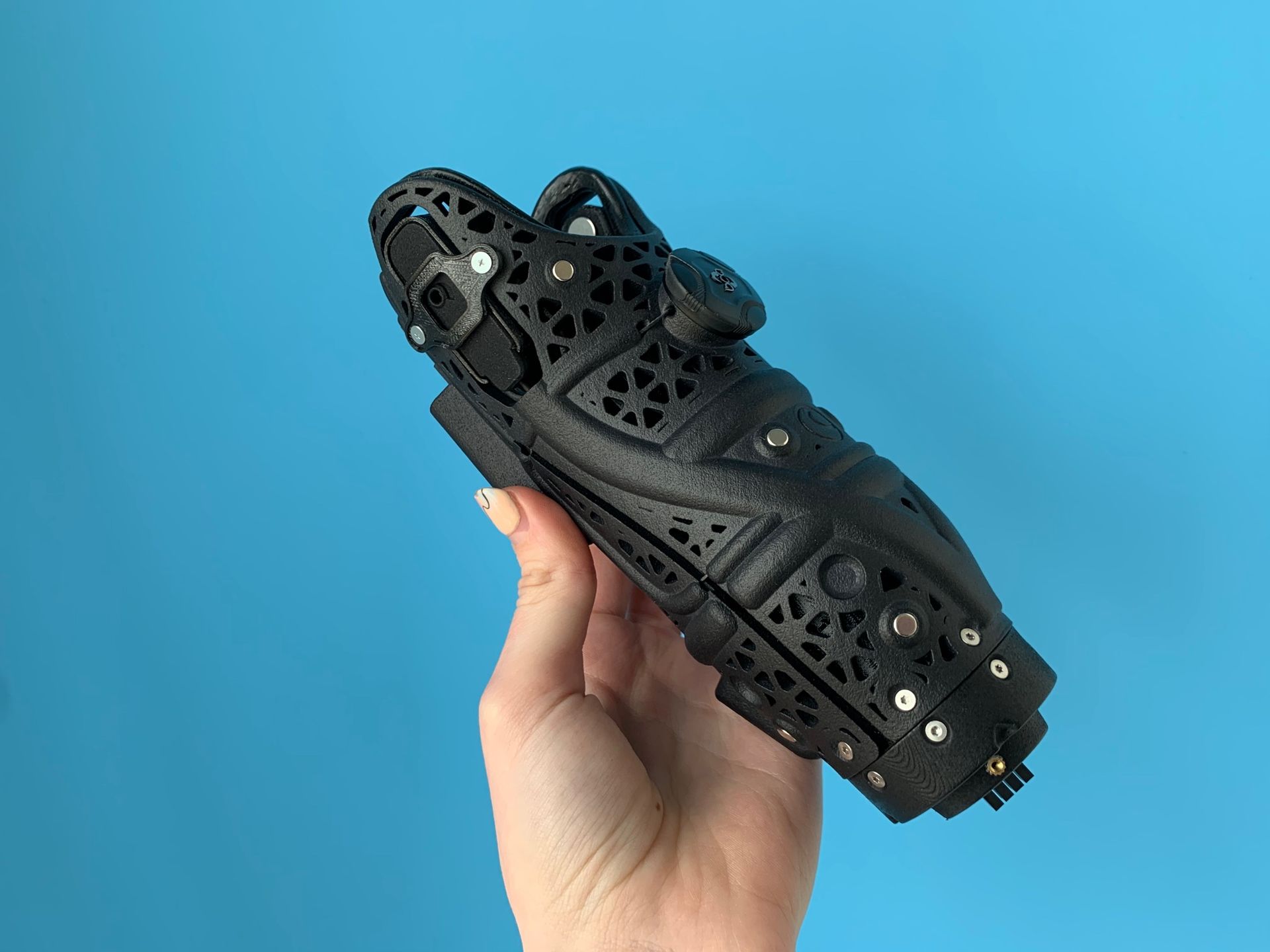 Open Bionics arms are built from Nylon PA12, a high-performance material used in industrial 3D printing. PA12 is strong enough to house motors, wiring, and joints while remaining significantly lighter than metal alternatives. The inner socket is printed in a flexible material with a vented design to allow airflow and reduce heat during extended wear.